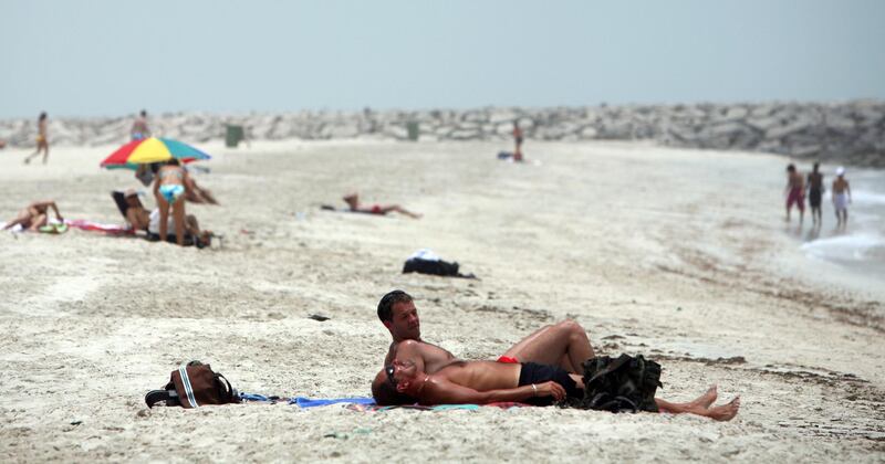 June 10, 2008 / Abu Dhabi /  Sun bathers relx on Ras Al Akhdar Beach in Abu Dhabi June 11, 2008. (Sammy Dallal / The National) *** Local Caption ***  sd-sunbather2.jpgsd-sunbather2.jpg