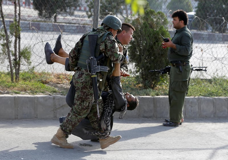 ATTENTION EDITORS - VISUAL COVERAGE OF SCENES OF INJURY OR DEATH  Afghan soldiers carry an injured man after a blast in Kabul, Afghanistan July 22, 2018.REUTERS/Omar Sobhani