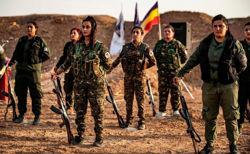 Members of the Bethnahrin Women Protection Forces line up in the countryside outside Tall Tamr in the northwestern Syrian province of Hasakah. AFP