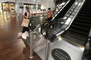 Shoppers wear face masks in a crowd-free Dubai Mall last week. AFP