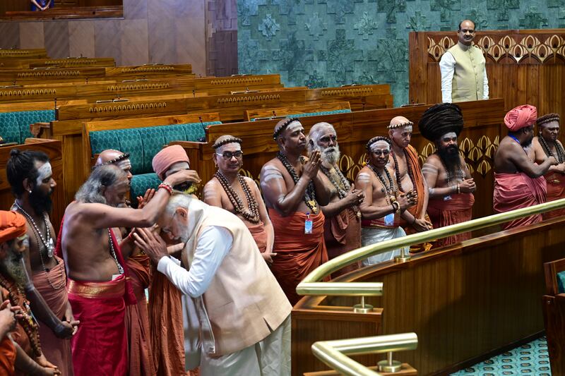 Mr Modi greets Hindu priests. AP