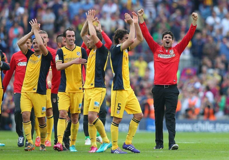 Diego Costa, far right, of Atletico Madrid celebrates winning La Liga with his teammates following the conclusion of their match against Barcelona on Saturday. Alex Livesey / Getty Images / May 17, 2014