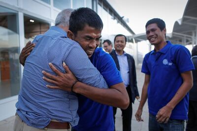 epa05599768 An unidentified Asian sailor (C) hugs John Steed (L), coordinator of the Hostage Support Partners (HSP) who helped negotiate the release, upon his arrival at the Jomo Kenyatta International Airport after they were released by Somali pirates, Nairobi, Kenya, 23 October 2016. According to reports, 26 Asian sailors, the crew of a Taiwan-owned Omani-flagged fishing vessel FV Naham 3, have been freed after having been held hostage since their boat was seized south of the Seychelles in March 2012. The freed sailors from Vietnam, Taiwan, Cambodia, Indonesia, China and the Philippines, were transported to Nairobi from Somalia before heading back to their respective countries.  EPA/DAI KUROKAWA *** Local Caption *** 53084802