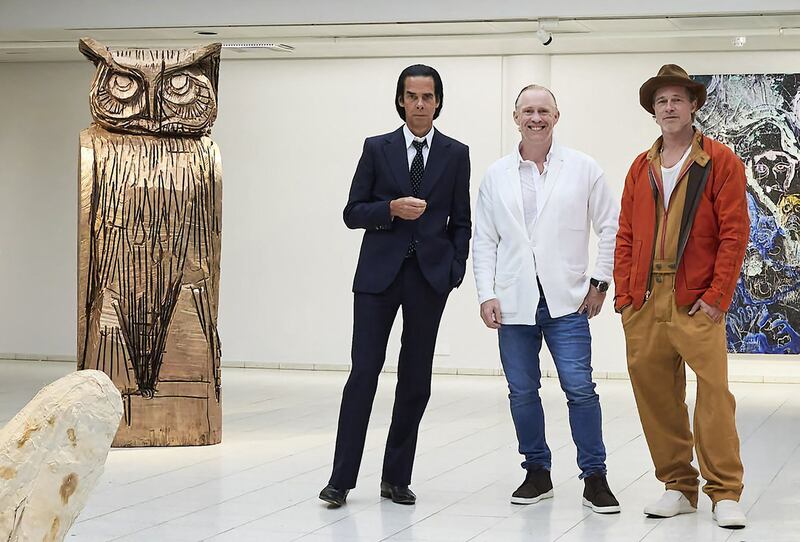 British artist Thomas Houseago, centre, poses with American actor Brad Pitt, right, and Australian musician Nick Cave at the Sara Hilden Art Museum in Tampere, Finland. AFP