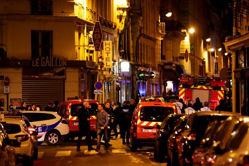 Policemen and emergency service members stand in a blocked street in Paris centre after one person was killed and several injured by a man armed with a knife, who was shot dead by police in Paris on May 12, 2018. The attack took place near the city's main opera house. Police indicated that the attacker had been "overcome" and his motives are unknown. The man attacked five people with a knife, one of whom died, police said. Two were in serious condition and all the victims are in hospital.
 / AFP / Thomas SAMSON
