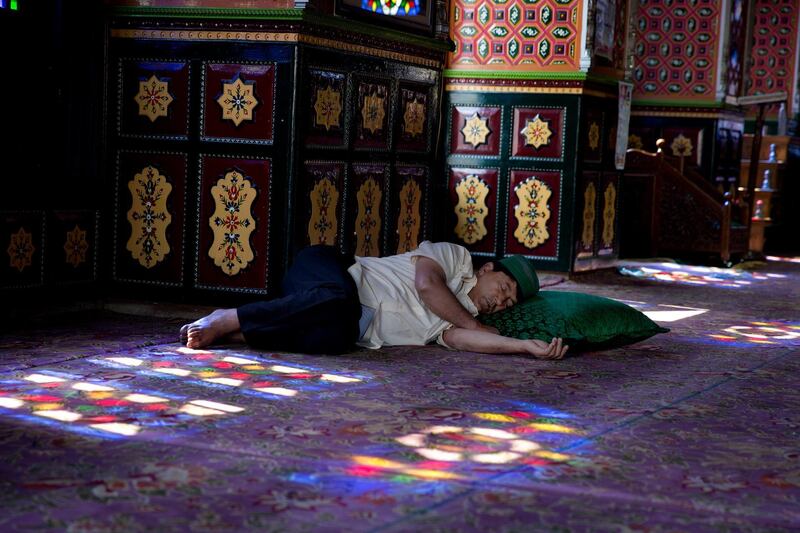 A Kashmiri man takes a nap inside the shrine of Sufi saint Shiekh Abdul Qadir Jeelani during the holy fasting month of Ramadan in Srinagar, Indian controlled Kashmir. AP Photo