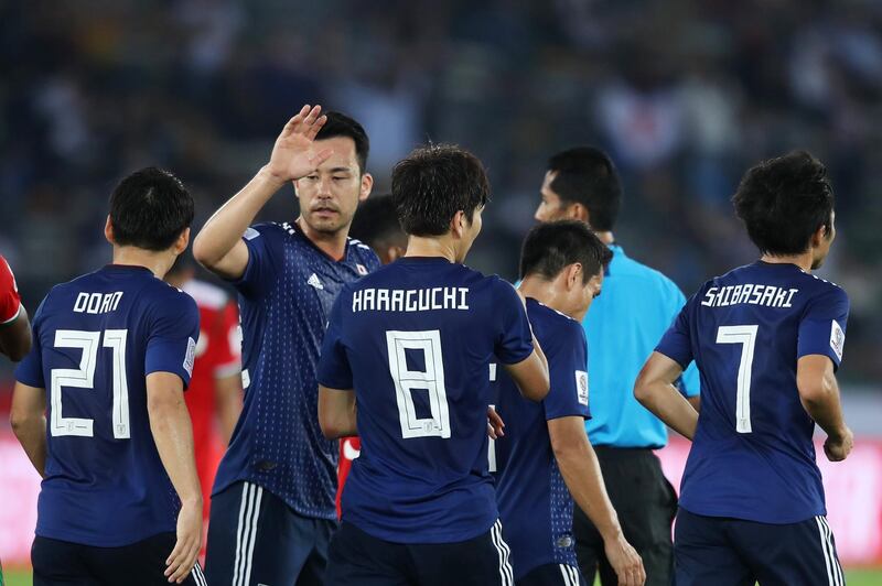 Genki Haraguchi of Japan celebrates with teammates after scoring a goal. Getty Images