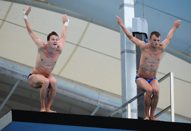 Germany's Patrick Hausding and Sascha Klein compete in the final of the men's 10-metre synchronised platform diving event of the FINA World Championships at the outdoor diving pool at the Oriental Sports Centre in Shanghai on July 17, 2011.  Germany's Patrick Hausding and Sascha Klein won silver.   AFP PHOTO / MARK RALSTON
 *** Local Caption ***  437499-01-08.jpg