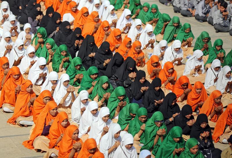 Muslim students pray during a ceremony to pay tribute to Central Reserve Police Force personnel who were killed after a suicide bomber rammed a car into the bus carrying them in south Kashmir. Reuters