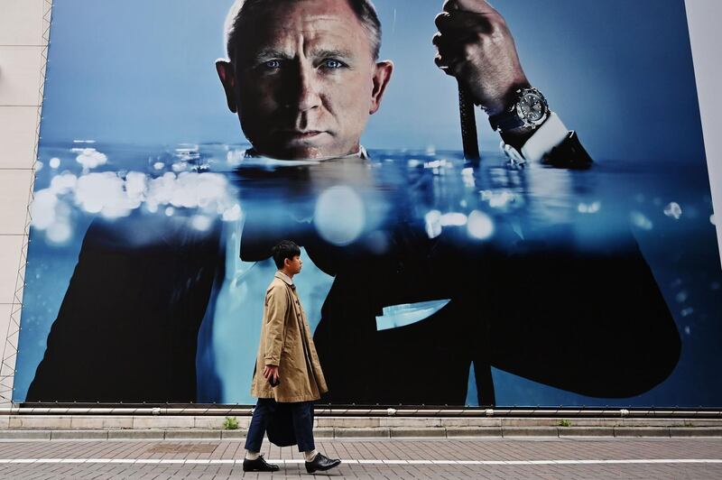 A man walks past an advertisement on a street in Tokyo's Ginza district. AFP