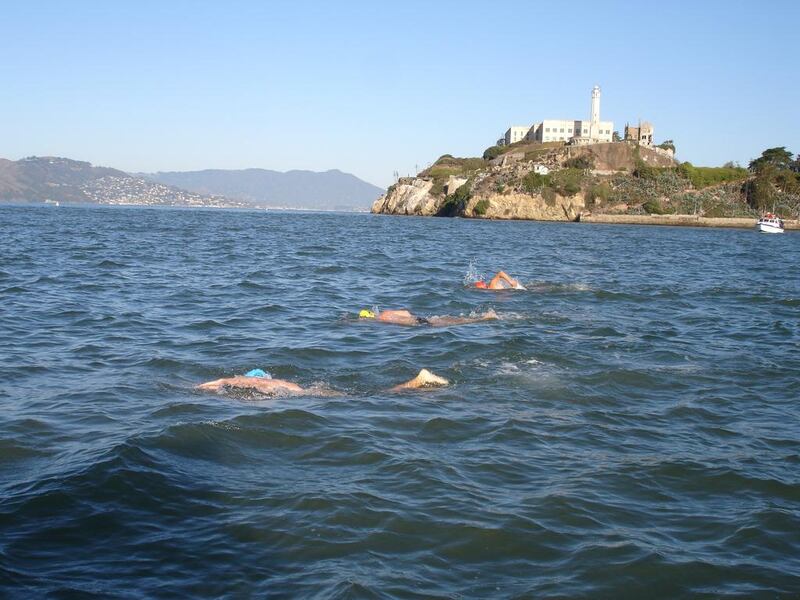 Peter Gibson and his two sons – William (blue cap) and Nicholas (red cap) – took on the Alcatraz swim during the Eid break. Courtesy Peter Gibson