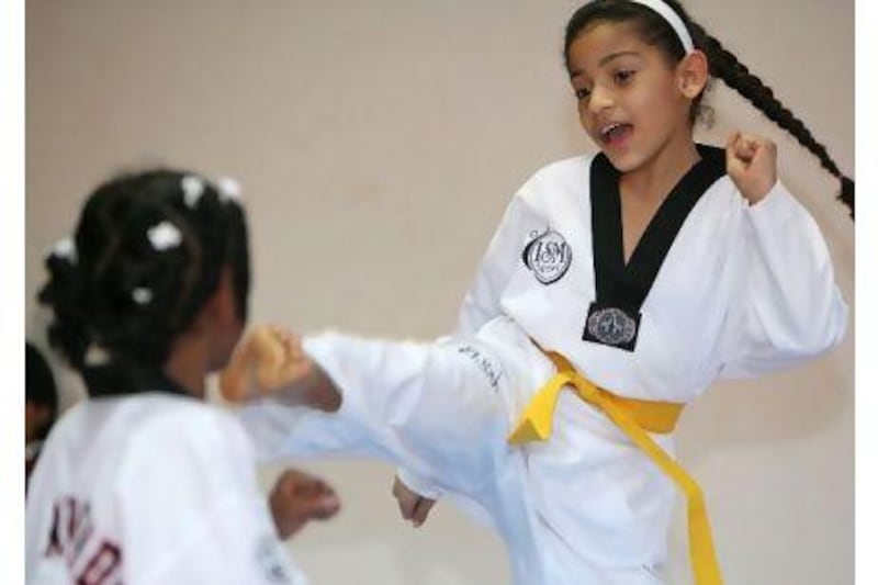 Suaad Rashid Mesmari, 9, right, spars with Mahra Nabil Mesmari, 8, left, during a tae kwon do class in Fujairah.