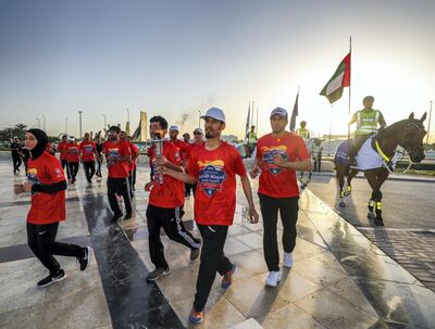 Abu Dhabi, UAE.  March, 14, 2018.  Law Enforcement Torch Run, Final Leg for Special Olympics.  The runners reach the Grand Mosque torch area with the AUH  Police Hose Division as their escort.  (Left) Zahra Lari, UAE figure skater.
Victor Besa / The National