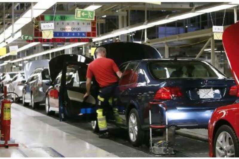 Workers monitor the production line at the Saab automobile factory in Trollhattan, Sweden on October 2007. Bloomberg News