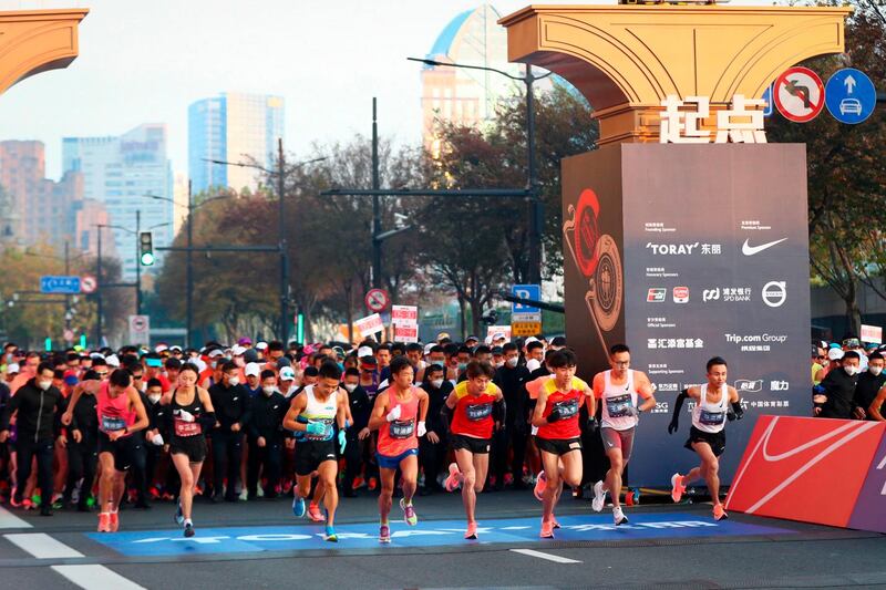 Runners run from the start line during the 2020 Shanghai marathon. AFP