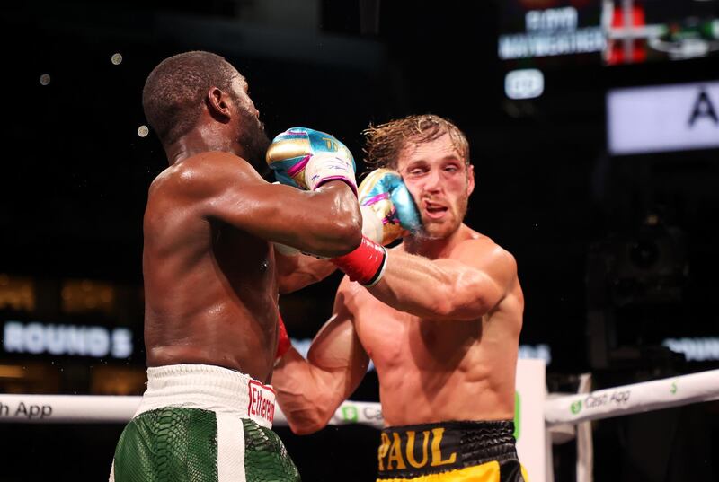 Floyd Mayweather lands a punch on Logan Paul during their exhibition bout at Hard Rock Stadium. AFP