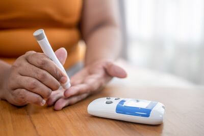 A blood sugar finger-prick test with a portable glucometer. Getty Images