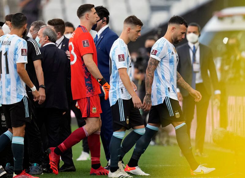 Argentina players Nicolas Otamendi, Giovani Lo Celso and goalkeeper Emiliano Martinez walk off the field. AP