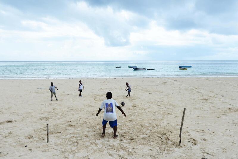 2A7X860 Comoran boys playing football on Mitsamiouli beach in Comoros. Alamy