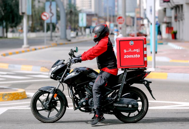 Abu Dhabi, United Arab Emirates, March 27, 2020.  A Zomato delivery man on his motorcycle on a nearly empty streets at downtown Abu Dhabi on the first day of the UAE cleaning campaign.  Emiratis and residents across the UAE must stay home this weekend while a nationwide cleaning and sterilisation drive is carried out. 
Victor Besa / The National