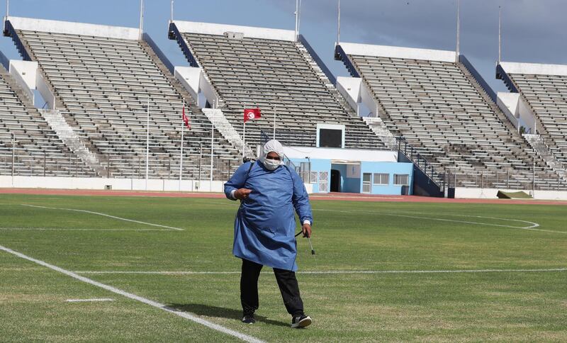 A Tunisian public health worker disinfects El Menzah Olympic Stadium in Tunis.  EPA