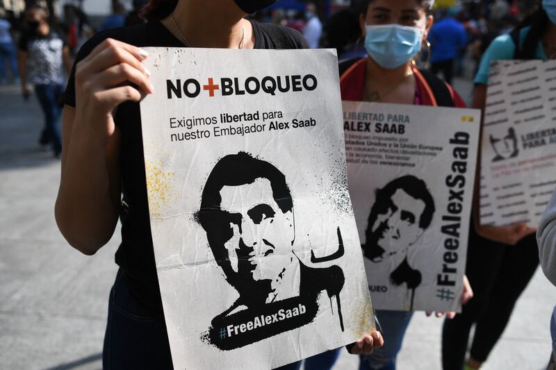 People hold placards with the image of Colombian businessman Alex Saab, who was extradited to the US, during a demonstration demanding his release in Caracas on Sunday. Photo: AFP