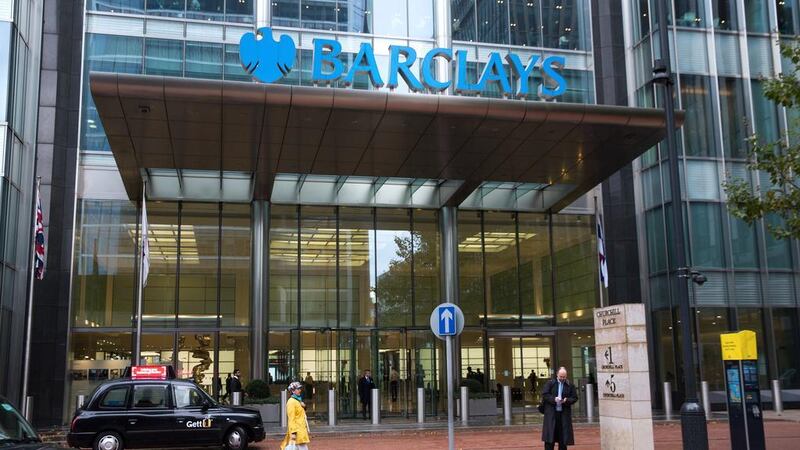 A London taxi cab sits in front of the Barclays headquarters in the Canary Wharf business, financial and shopping district of London. Barclays posted a second quarter net loss. Simon Dawson / Bloomberg