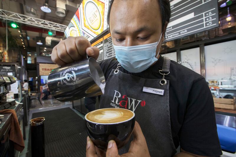 A staff member brews a cup at the Raw Coffee Company in Dubai.  Ruel Pableo for The National