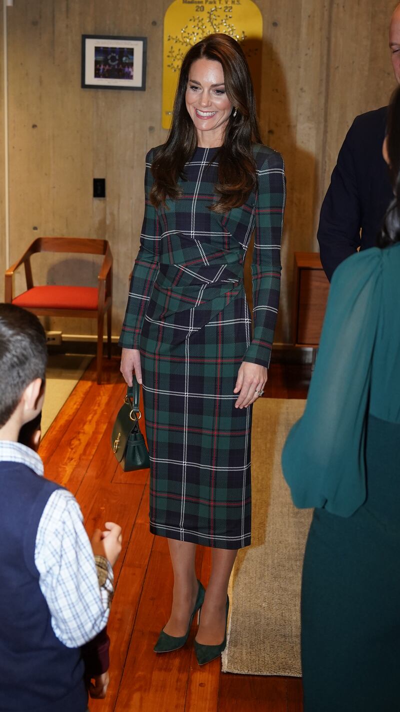 Kate wore a tartan dress by Burberry to meet Wu and her children. PA