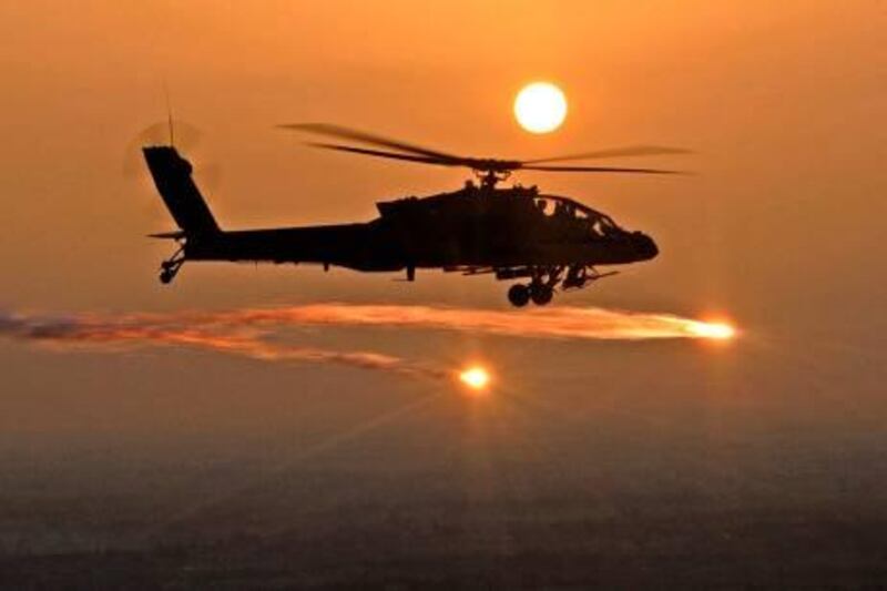 A picture released by the US military 07 June 2007, shows an AH-64D Apache helicopter firing flares as soldiers from the 227th Aviation Regiment, 1st Air Cavalry Brigade, 1st Cavalry Division, based at Camp Taji, conduct a mission over Iraq, 29 April 2007. At least 14 people were killed and 30 wounded today in two near simultaneous vehicle bombs north of Basra, the southern Iraqi city, police and medical officials told AFP. AFP PHOTO/HO/Chief Warrant Officer Daniel McClinton