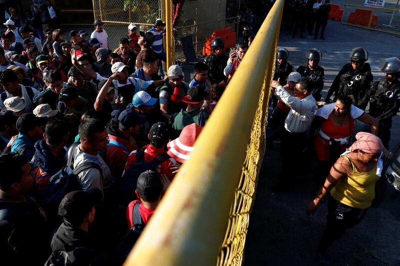 A large group of Salvadorians gather near the border gate between Guatemala and Mexico, to start their immigration documents to carry on their journey, in Tecun Uman, Guatemala. Reuters
