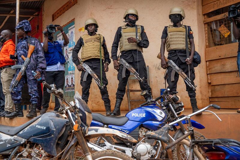 Security forces stand outside a polling station in Kampala, Uganda. AP Photo