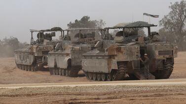 Israeli armoured personnel carriers gather on the Israeli border near the city of Rafah in southern Gaza on Thursday. EPA