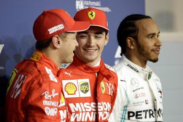 Ferrari driver Charles Leclerc, centre, smiles after taking the first pole position of his career in Bahrain. AP Photo