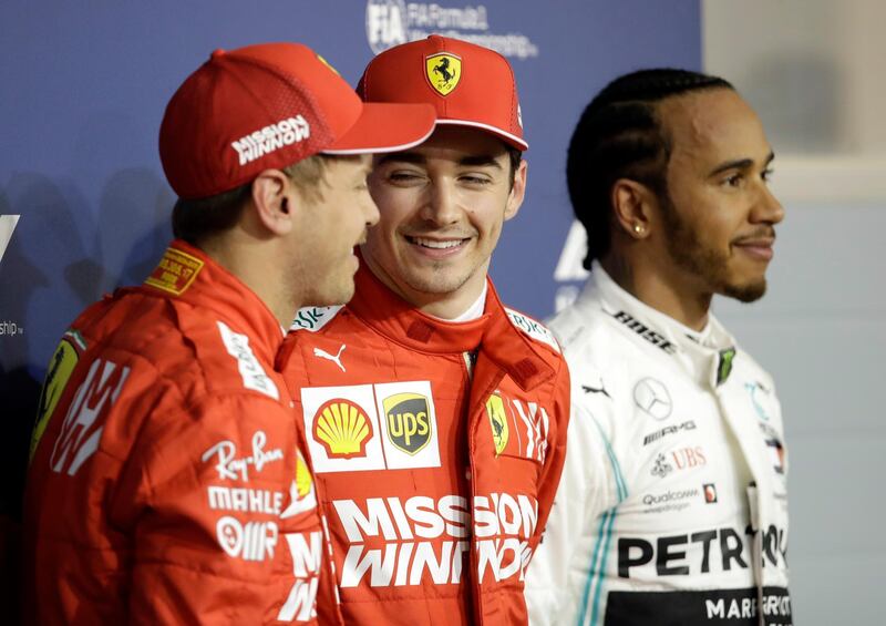 Ferrari driver Charles Leclerc of Monaco, center, celebrates his pole position with runner up Ferrari driver Sebastian Vettel of Germany, left and Mercedes driver Lewis Hamilton of Britain after the qualifying session at the Formula One Bahrain International Circuit in Sakhir, Bahrain, Saturday, March 30, 2019. The Bahrain Formula One Grand Prix will take place on Sunday. (AP Photo/Luca Bruno)