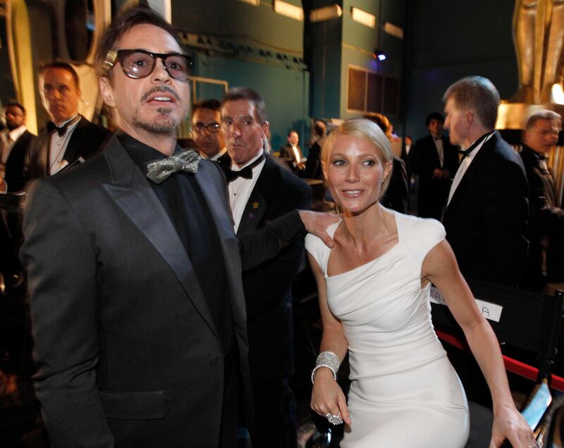 Robert Downey Jr., left, and Gwyneth Paltrow are seen backstage at the 84th Academy Awards on Sunday, Feb. 26, 2012, in the Hollywood section of Los Angeles. (AP Photo/Chris Carlson)