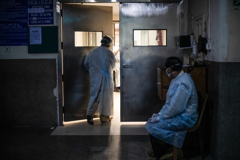 A worker caring for Covid-19 patients takes a break in the ICU ward at the Holy Family hospital in New Delhi, India. Getty