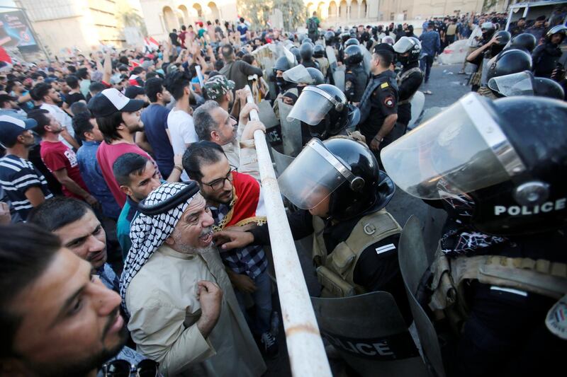 Riot police attempt to disperse crowds during the protest in Baghdad. Reuters