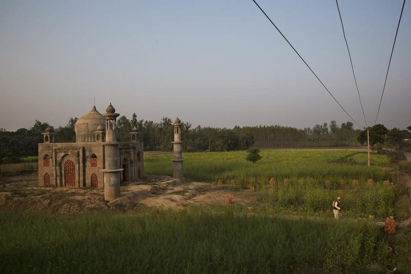 Retired postman Faizul Hassan Qadri, 79, leaving the monument he is building for his late wife Tajammuli in the town of Kaser Kalan, in the Indian state of Uttar Pradesh.

Bernat Armangue / AP Photo