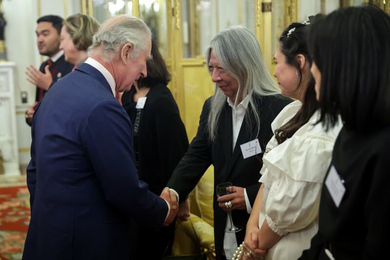 King Charles meets fashion designer John Rocha at Buckingham Palace. PA
