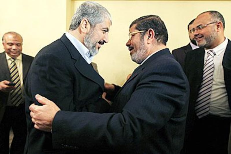 Khaled Meshaal, left, congratulates the head of Egypt's Freedom and Justice Party, Mohammed Morsi, on his electoral success.