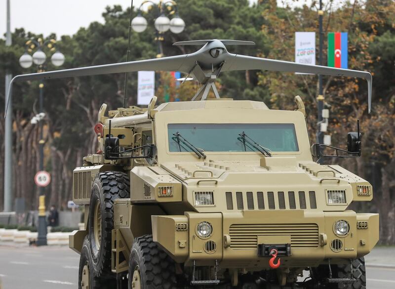 An Azeri army armoured vehicle with mounted with a drone drives during the parade in Baku. Reuters