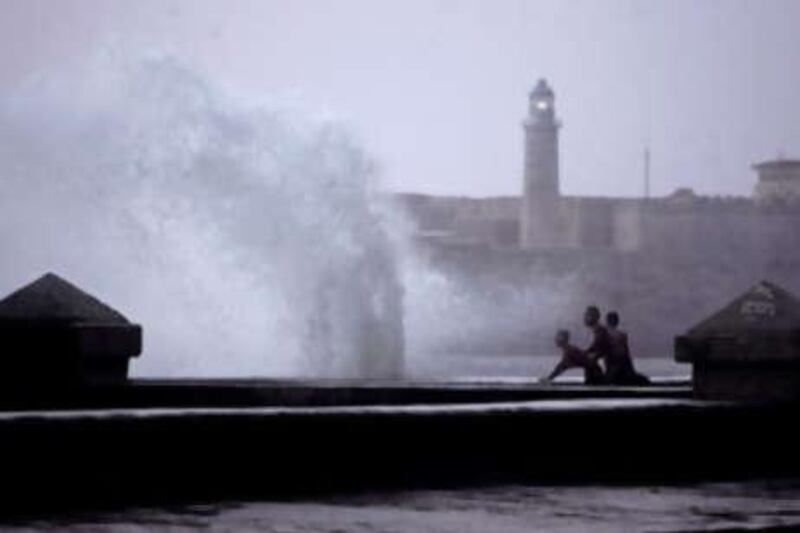 Locals look at waves battering the Malecon waterfront in Havana, before the arrival of Hurricane Ike.
