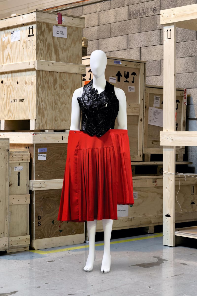 Martin Margiela, 'Artisanal' spring / summer 2001: Backless top made from assembled vintage black gloves, with a pleated red skirt made of assembled vintage skirts. Photo: Sotheby's