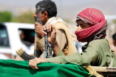 An armed supporter of Yemen's Houthi rebels attends a funeral procession for fighters killed in battles with government troops in the Marib region, on March 23, 2021 in the capital Sanaa. AFP