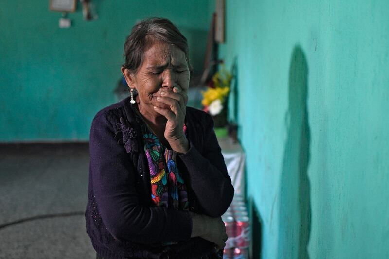 Another relative of Wilmer cries at his home in Guatemala. AFP