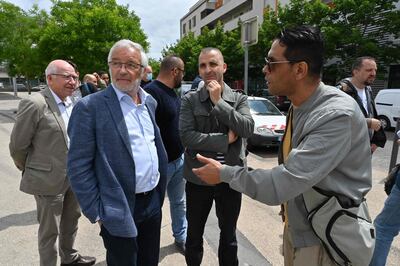 Mayor of Dijon Francois Rebsamen (L) talks with people in the street in the Gresilles area of Dijon, eastern France, on June 16, 2020, as new tensions flared in the city after it was rocked by a weekend of unrest blamed on Chechens seeking vengeance for an assault on a teenager. / AFP / PHILIPPE DESMAZES
