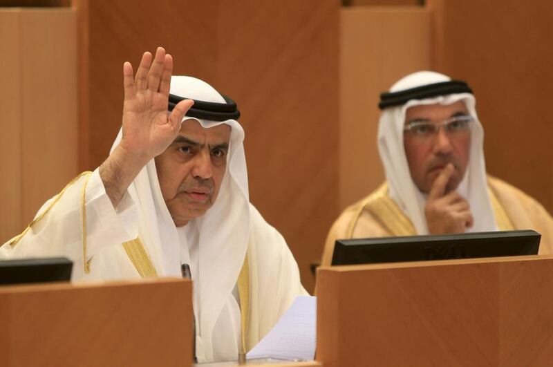 Obaid Al Tayer, Minister of State for Finance Affairs, left, and Khalid Al Bustani, the new Director-General of the Federal Tax Authority, at the FNC session in Abu Dhabi. Ravindranath K / The National