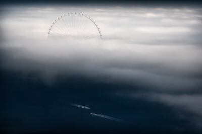 'Day Fog with Boats' by Ahmad Alnaji shows fog up to the wheel's midsection and two boats in the water below. Photo: Ahmad Alnaji