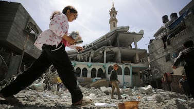 DEIR AL-BALAH, GAZA - APRIL 22: A child is seen after the Al Taqwa Mosque hit during an Israeli airstrike in the Al Bureij refugee camp located in Deir al- Balah, Gaza on April 22, 2024. The attack resulted in partial destruction of the mosque and damage to surrounding buildings. (Photo by Ashraf Amra/Anadolu via Getty Images)